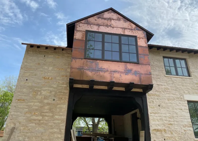 Copper metal panel facade on a stone building for Metal Roof Coating in Canfield